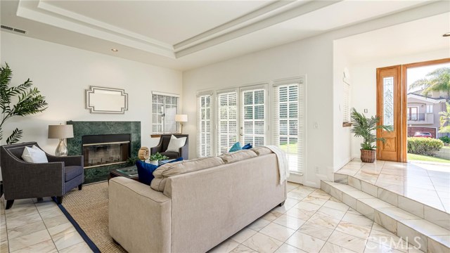 Living room with formal entry.French doors lead out to the patio and grassy front yard.