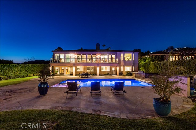 Showstopping pool view of the home at night