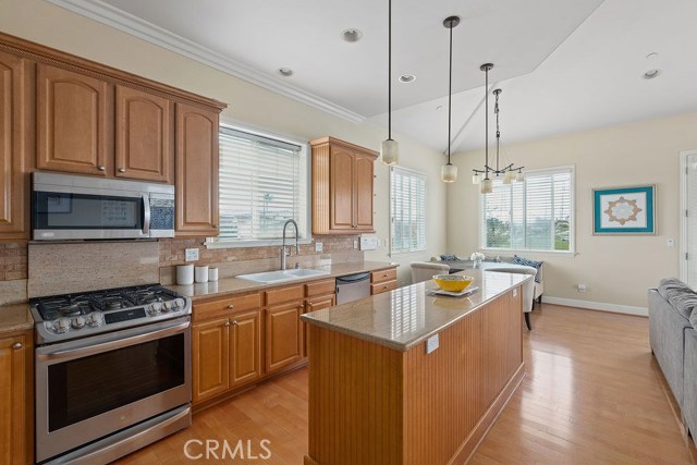 Fresh and bright kitchen with granite counter tops, stainless appliances, center island, ...