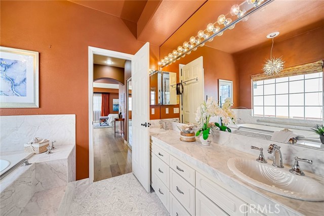 View of master bathroom from shower area with master bedroom and two closets in the background.