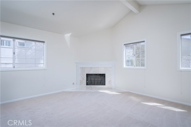 Master bedroom with vaulted ceilings, fireplace, new carpeting.
