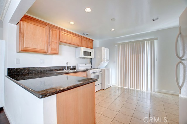 Unit B kitchen and laundry area. Washer, dryer and refrigerator included.