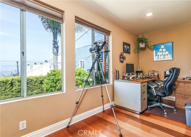 A corner of the sun porch has an area which makes the perfect bright office space, taking in the ocean views.