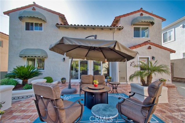 Tile patio with built in grill is situated between main house and garage bonus room