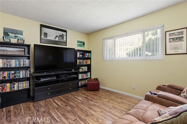 Bedroom on entry level. Windows look out at backyard.  Wouldn't a sliding door be nice in this room to open it up to the backyard?