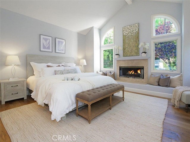 Master bedroom with vaulted ceilings and fireplace