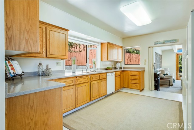 Spacious kitchen with Corian counters, garden window and adjoining breakfast nook and ocean view