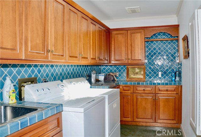 Laundry room with skylight and lots of storage.