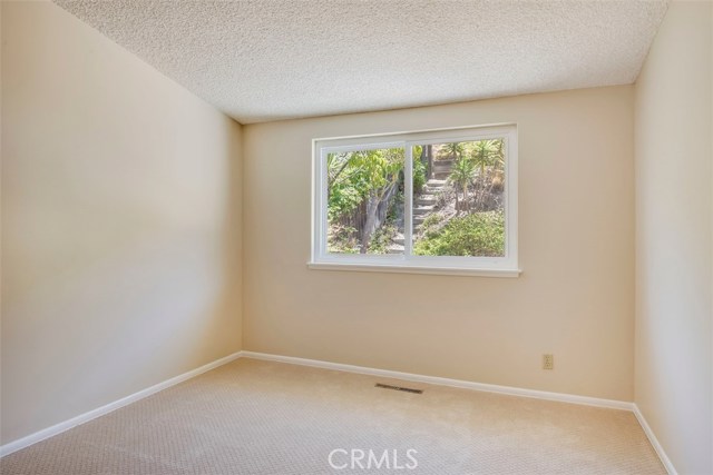 Back bedroom has good lighting and view to what could be your terraced backyard.