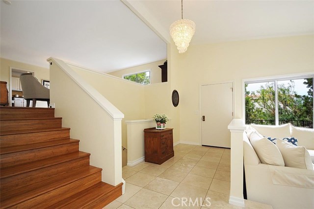 Front Door Entrance with Travertine flooring between Living Room and Family Room