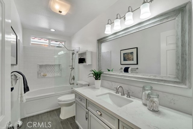 Completely Remodeled Bath with Quartz Countertops, Custom Fixtures, and Tile Accents to Match the New Floors. Completely Remodeled Bath with Quartz Countertops, Custom Fixtures, and Tile Accents to Match the New Floors.