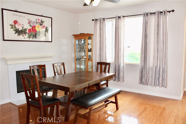 Dining area with fireplace, hardwood flooring