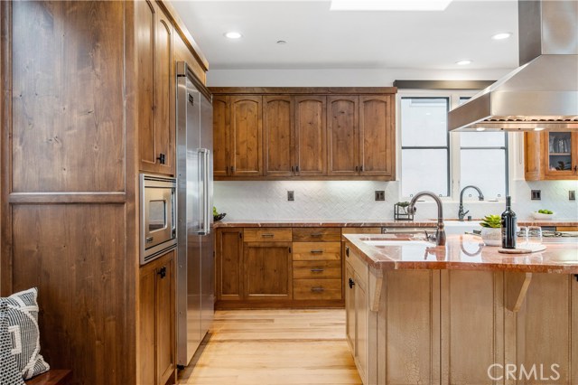 Kitchen features refinished hickory, wide plank hardwood floors, tons of cabinets and expansive counter space.
