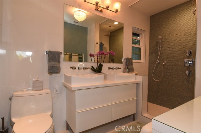 Stunning new master bathroom has the pretties blue tile shower!  Nice vanity area, too!