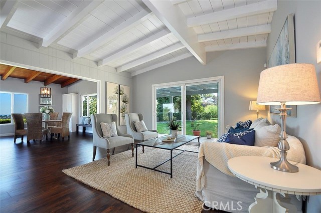 Living room with beamed ceilings and sliding doors to the large back yard.