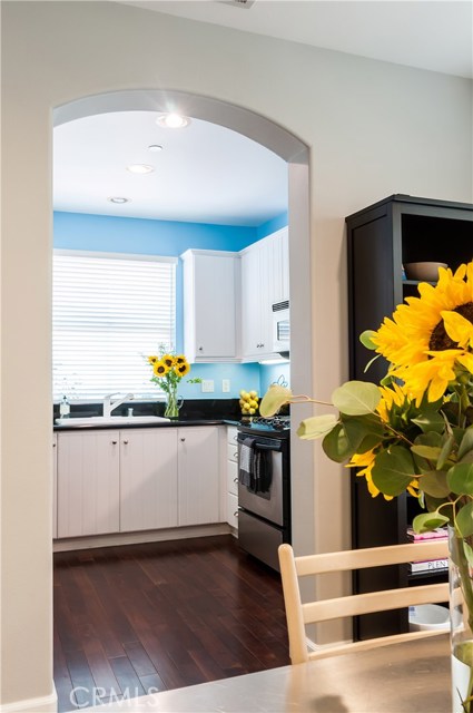 Archway leads to kitchen, located just off the dining area.