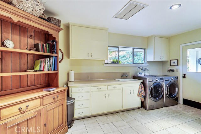 HUGE laundry room - approved plans provide for slightly expanding the footprint of the home, addition of a powder room and additional living space if the next family would prefer.