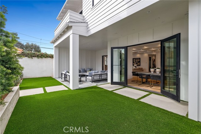 Private back yard with seating area and detached garage