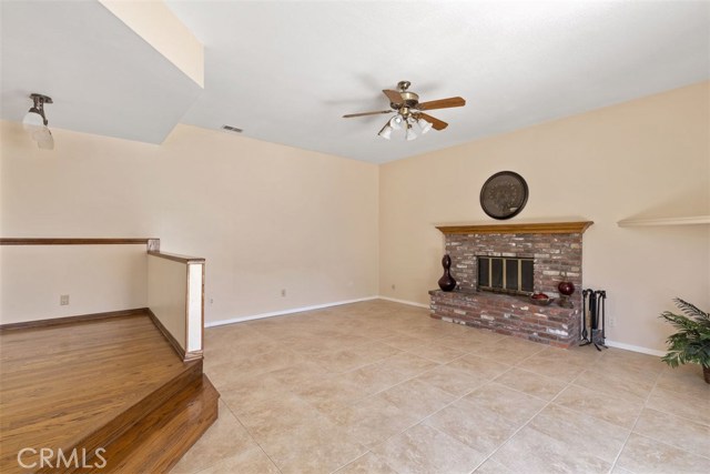 Expansive family room with cozy brick fireplace