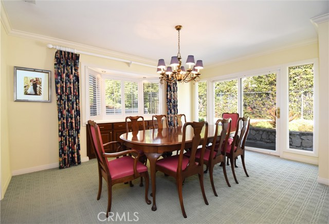 Formal dining room with built in buffet. Access to backyard and pool.