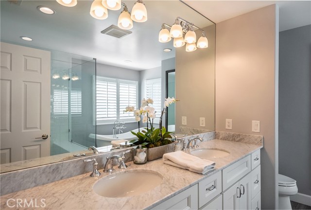 Gorgeous totally updated Master Bath with Carrara Marble, soaking tub, frameless shower doors