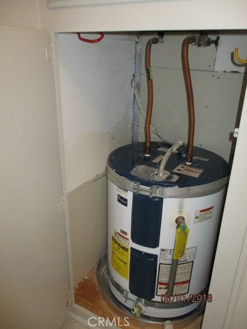 Electric water heater located inside hallway closet.