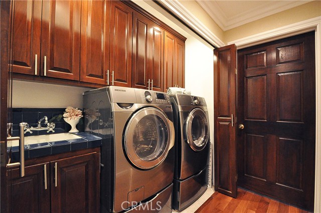 Washer and dryer included - this laundry area, including sink, is conveniently located near the bedrooms.