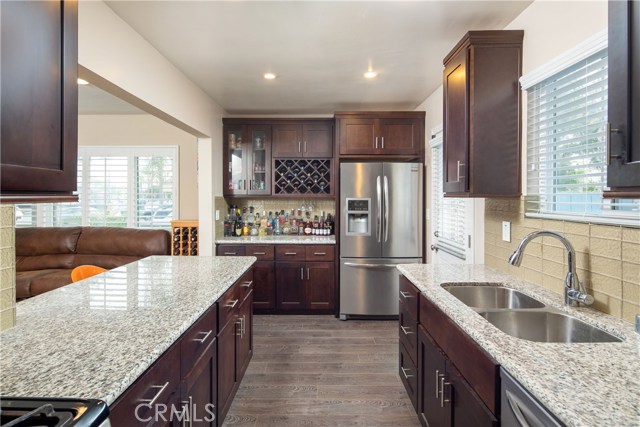 The kitchen offers ample storage with a dry-bar cabinet and counter.