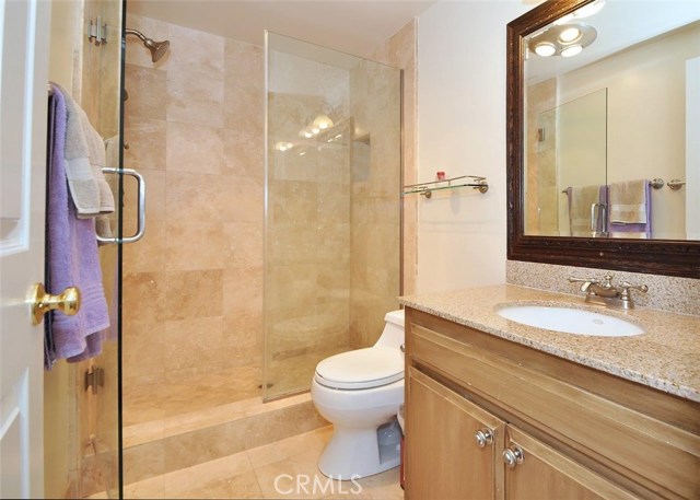 Remodeled 3/4 bath with travertine and granite.