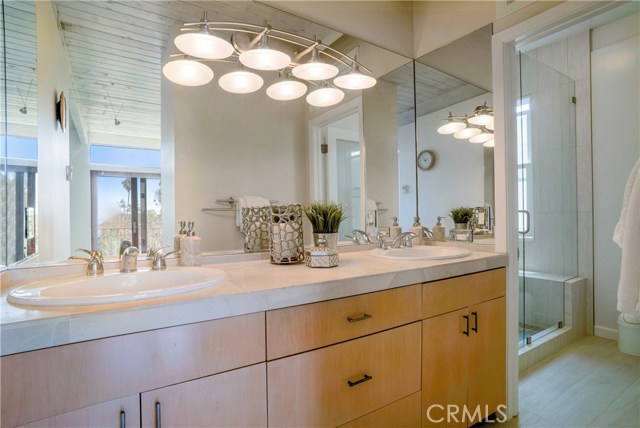 Stone counters and dual vanities at master bath.  Enjoy views of the outdoors from your mirror.