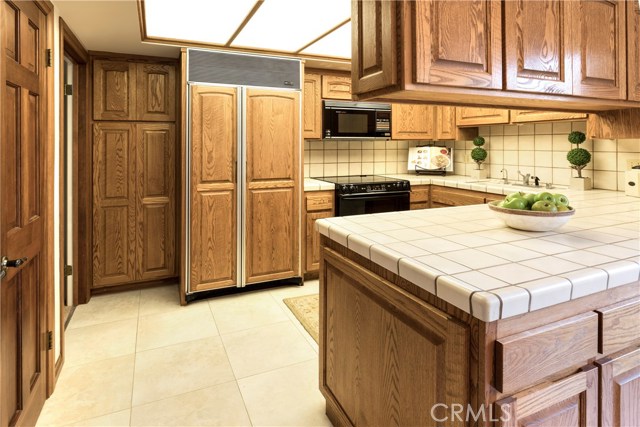 Kitchen with Sub Zero refrigerator; Walk-in Pantry is on the very left-hand side.