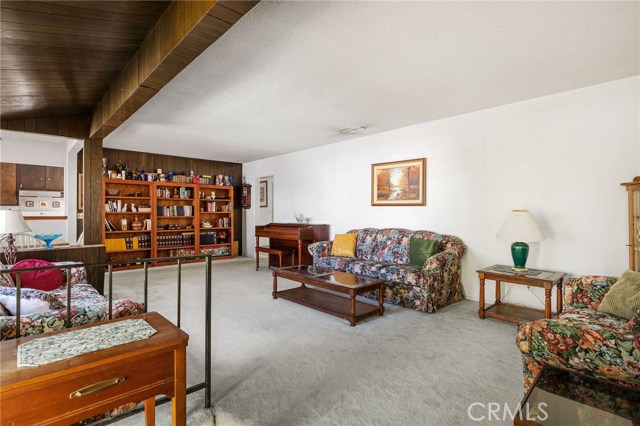 Large spacious living room. Kitchen at left. Dining area at left also.
