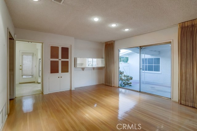 Spacious Family/Dining Room with hardwood floors and slider to patio area.