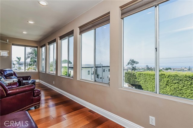 The West side of the great room has a sunporch sitting area which fronts the panoramic ocean views.