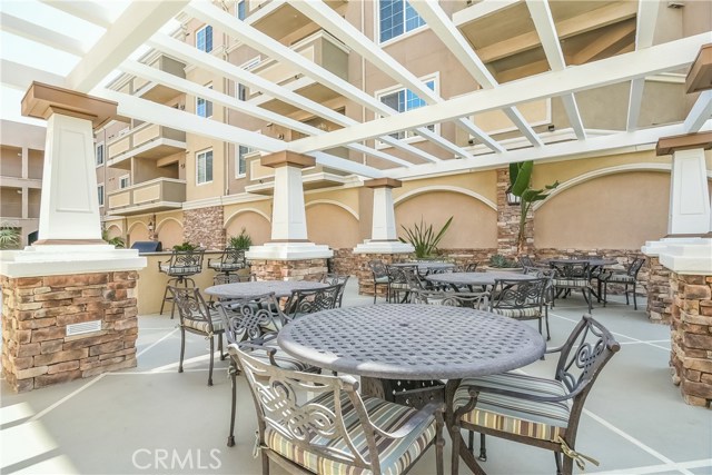 Common area in courtyard features BBQ and firepit.