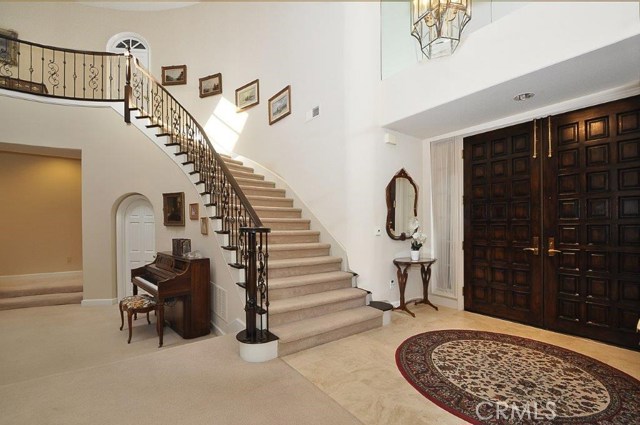 Spectacular Sweeping Staircase with Custom Wrought Iron Railing
