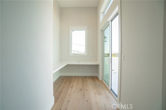 View of computer room/office room from hallway. Sliding door on the right hand side that opens to upper deck.
