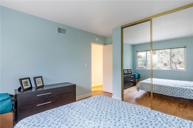 Bedroom 2 has ceiling-height mirrored closet doors.