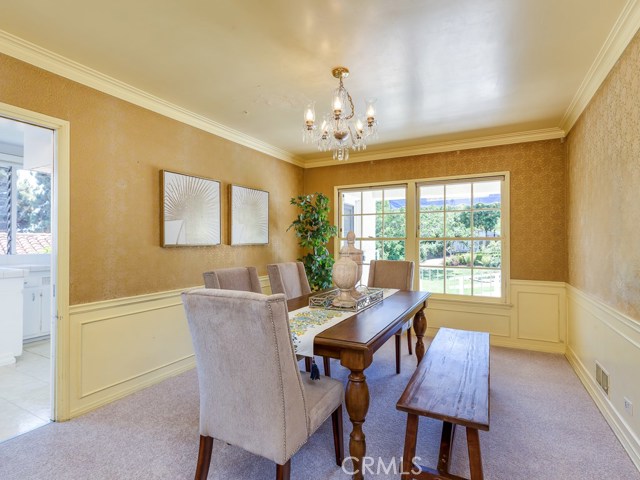 Formal dining room with easy access to kitchen and natural light from garden