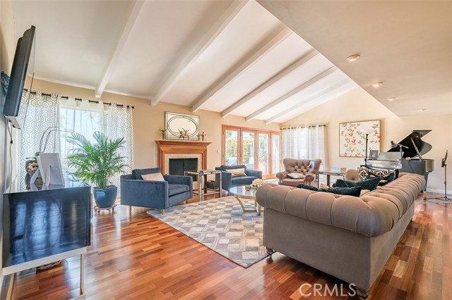 Formal living room with fireplace and natural lighting.