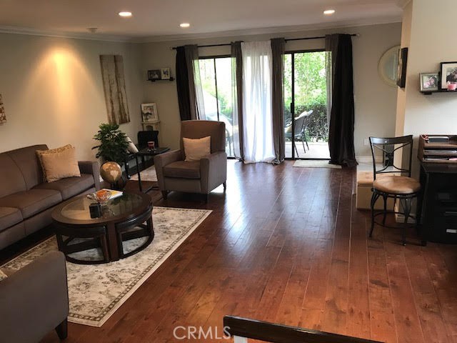 Living room to the front patio. The front door is to the right of the patio sliding door.
