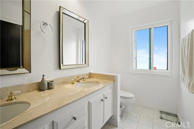 Primary suite bathroom with dual vanity and shower