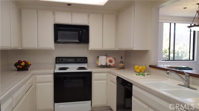 Spacious kitchen has all appliances including refrigerator, washer and dryer