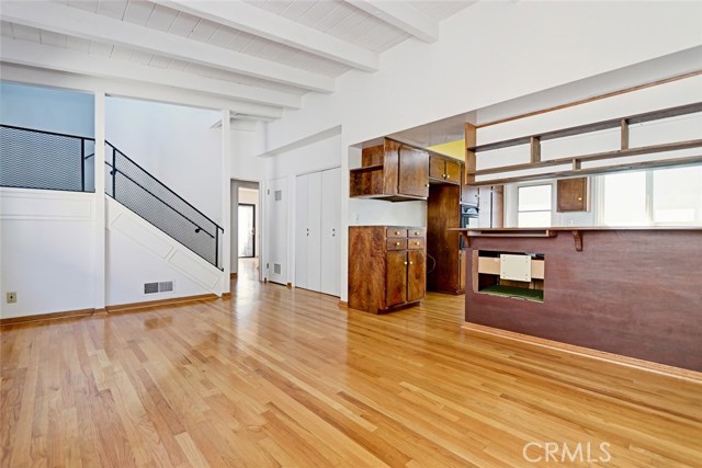 Original wood floors and original condition, this is the family room of the kitchen leading to 2 bedrooms on this level with access to the backyard. And up the stairs you'll find the master bedroom and bath.