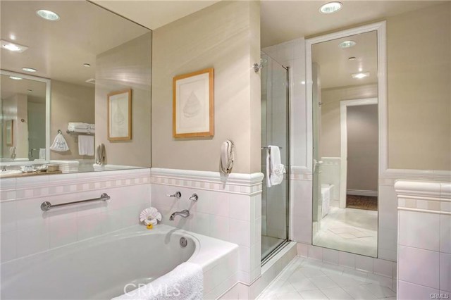 full bathroom with separate tub and shower