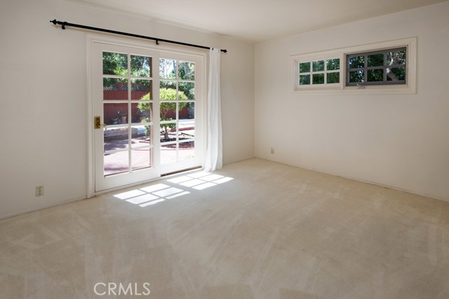 Back bedroom with doors to patio