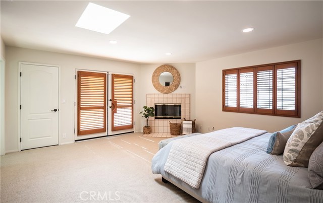 Master bedroom with wood burning fireplace and south-facing balcony