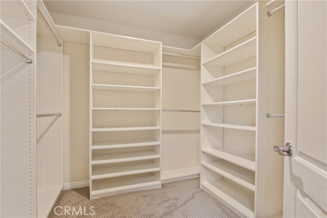 master suite walk in closet with built in shelving