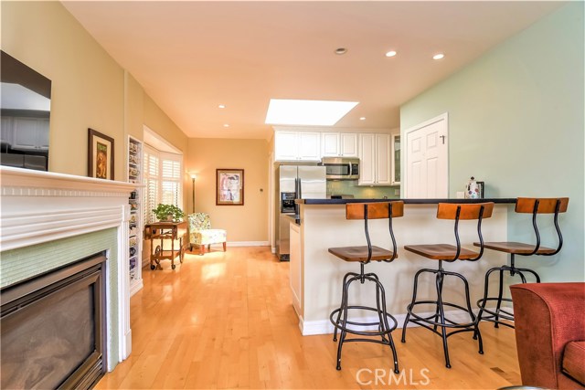 The living room leads to a breakfast dining area next to the open kitchen