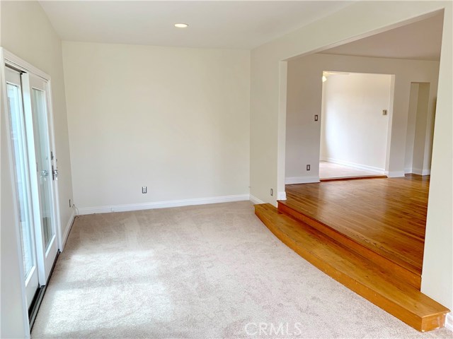 Den looking into living room and kitchen.
